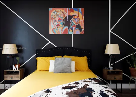 a bedroom with bed and wooden floor