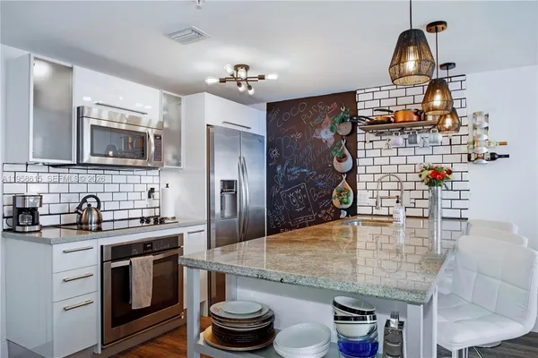a kitchen with sink refrigerator and stove
