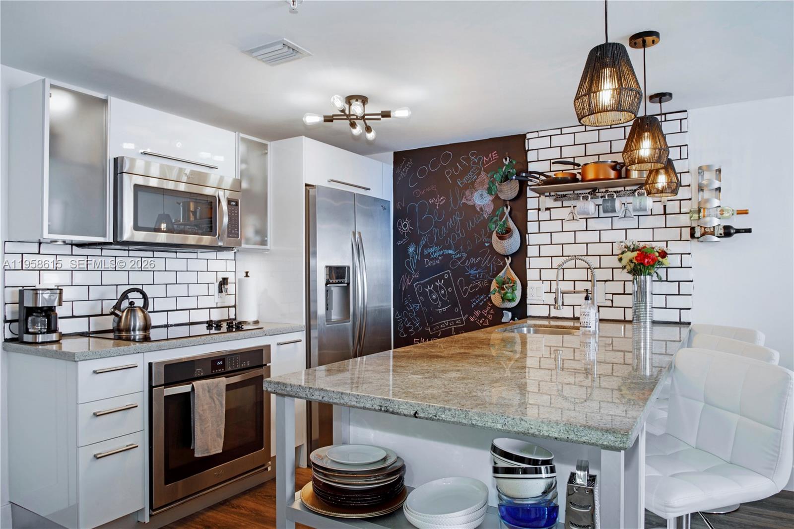 185 Southwest 7th Street, Unit 2514 Miami, FL 33130 - Photo 7 of 33 a kitchen with sink refrigerator and stove