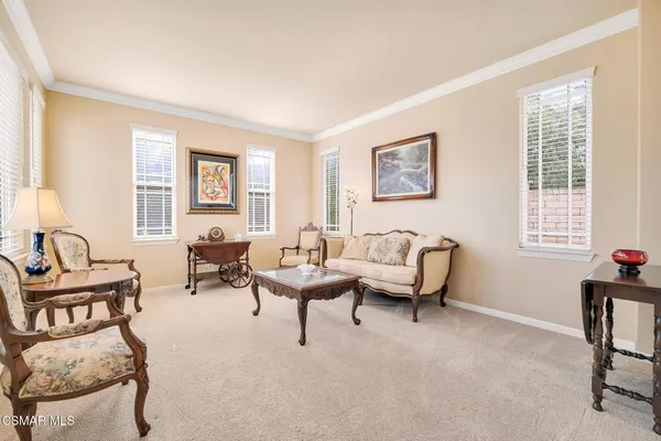 a view of a dining room with furniture wooden floor and a chandelier