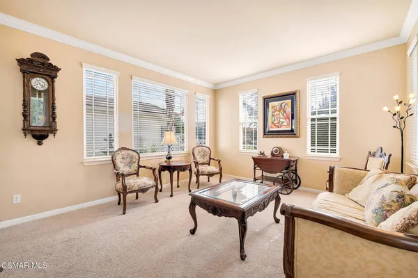 a view of a dining room with furniture and a chandelier