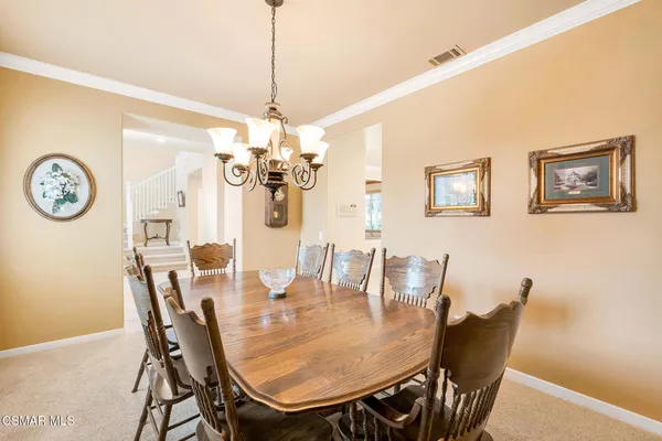 a kitchen with white cabinets and sink