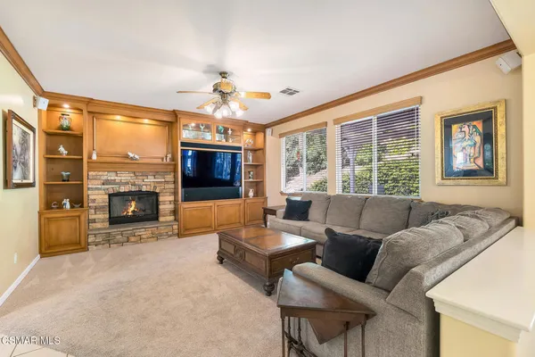 a kitchen with stainless steel appliances kitchen island granite countertop a refrigerator and a sink
