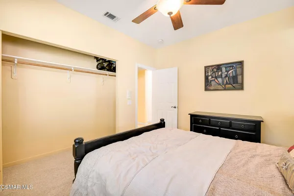 a bedroom with a bed a chandelier and a window