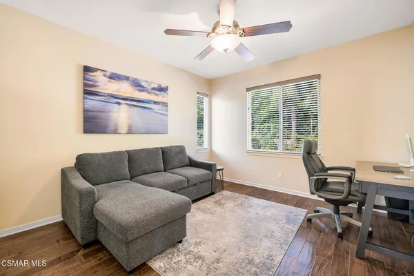 a bedroom with a bed window flat screen tv and a window