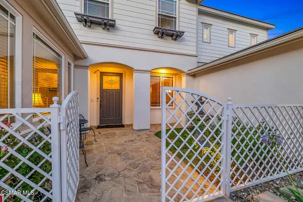a view of staircase with white walls and furniture