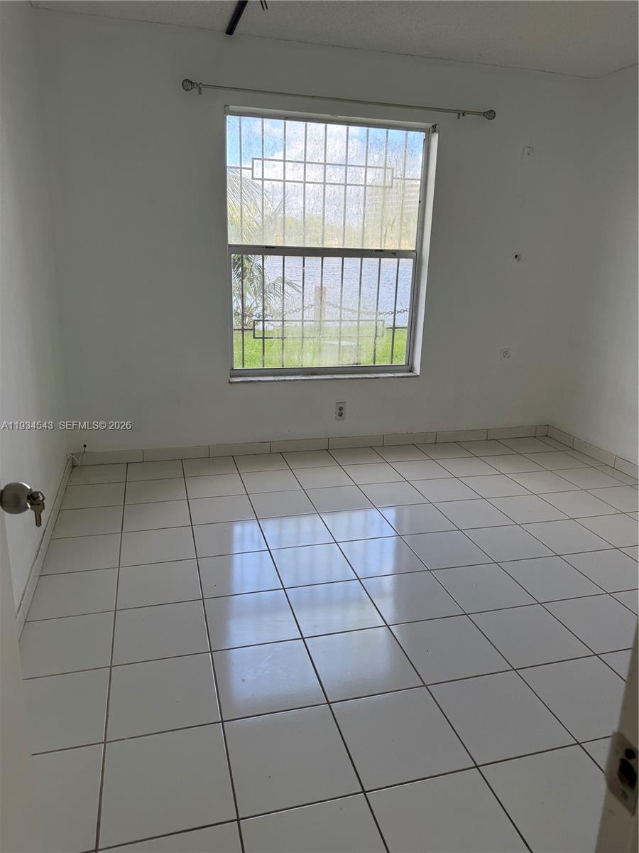 5199 Northwest 7th Street, Unit 115 Miami, FL 33126 - Photo 13 of 14 a view of an empty room with a window