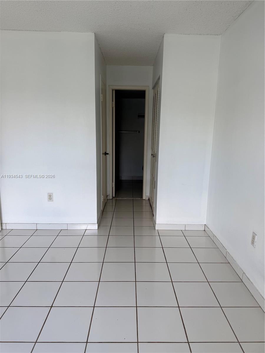 5199 Northwest 7th Street, Unit 115 Miami, FL 33126 - Photo 6 of 14 a view of an empty room and window