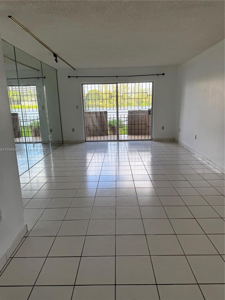 5199 Northwest 7th Street, Unit 115 Miami, FL 33126 - Photo 9 of 14 a view of an empty room and window