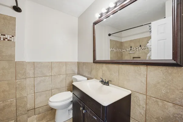 a bathroom with a sink mirror and toilet