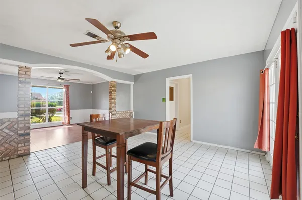a dining room with furniture and window