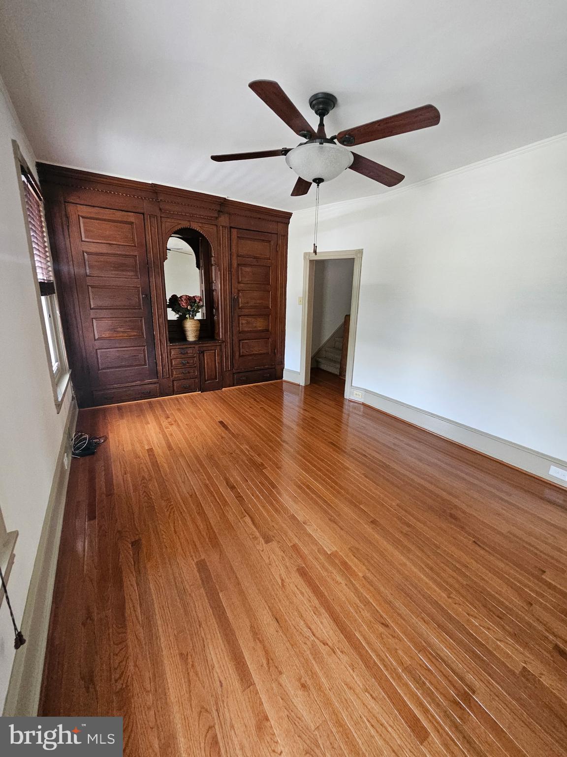 4356 Manayunk Avenue, Unit 2 Philadelphia, PA 19128 - Photo 12 of 43 an empty room with wooden floor ceiling fan and windows
