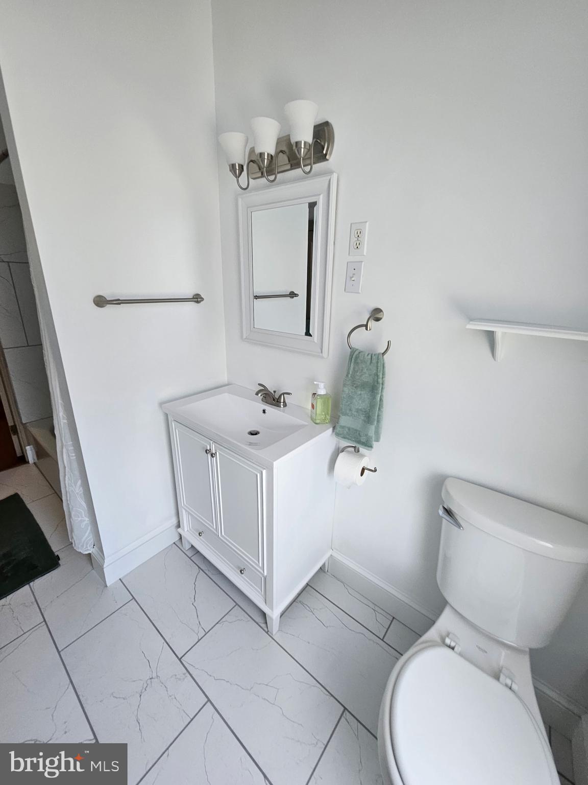 4356 Manayunk Avenue, Unit 2 Philadelphia, PA 19128 - Photo 13 of 43 a white toilet sitting next to a bathroom sink