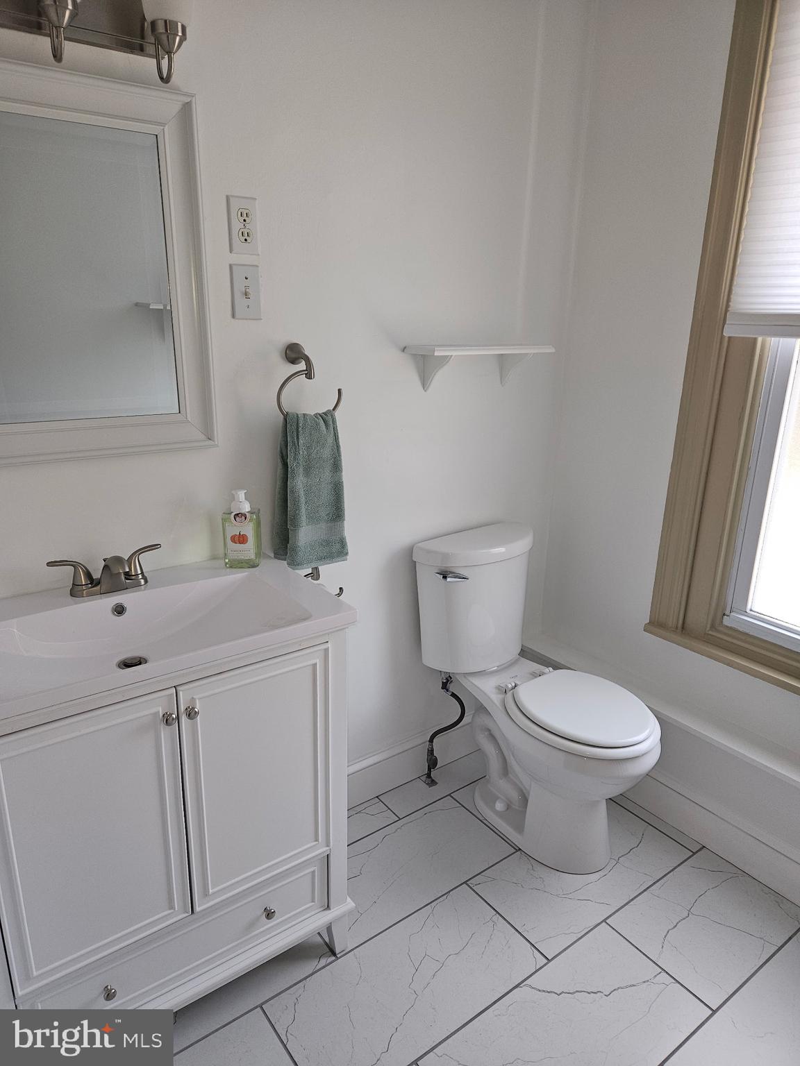 4356 Manayunk Avenue, Unit 2 Philadelphia, PA 19128 - Photo 18 of 43 a bathroom with a toilet sink and mirror