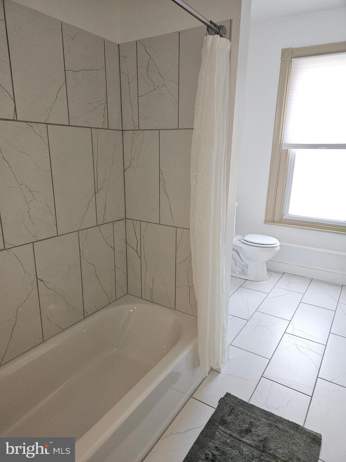4356 Manayunk Avenue, Unit 2 Philadelphia, PA 19128 - Photo 21 of 43 a bathroom with a bathtub and window