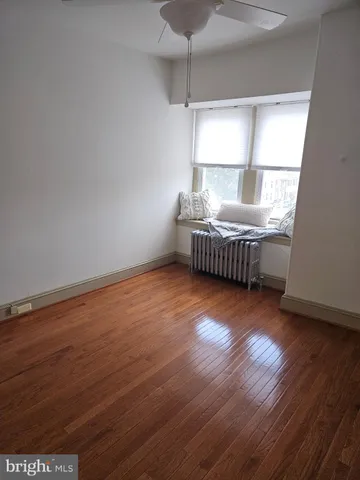 a view of room with window and wooden floor