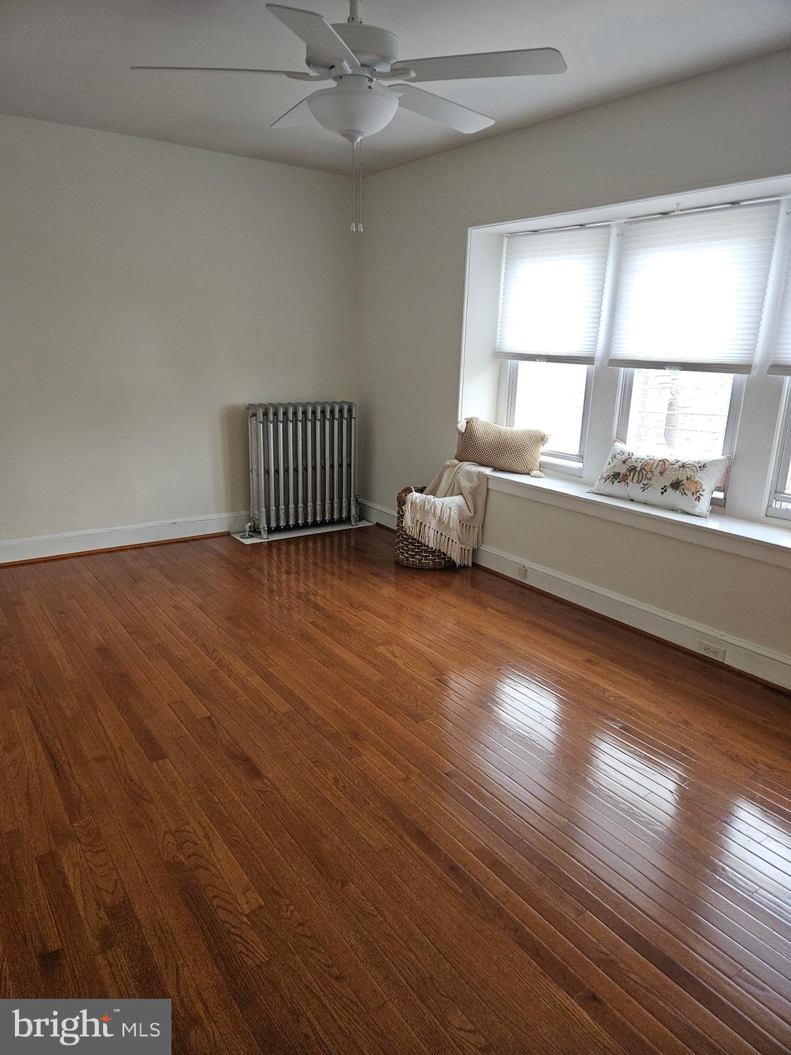 4356 Manayunk Avenue, Unit 2 Philadelphia, PA 19128 - Photo 27 of 43 an empty room with wooden floor fan and windows