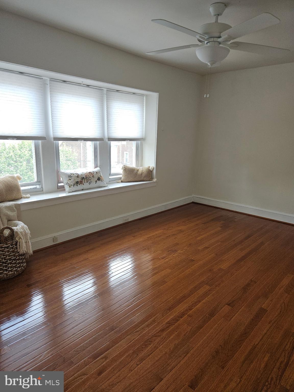 4356 Manayunk Avenue, Unit 2 Philadelphia, PA 19128 - Photo 32 of 43 an empty room with wooden floor and windows