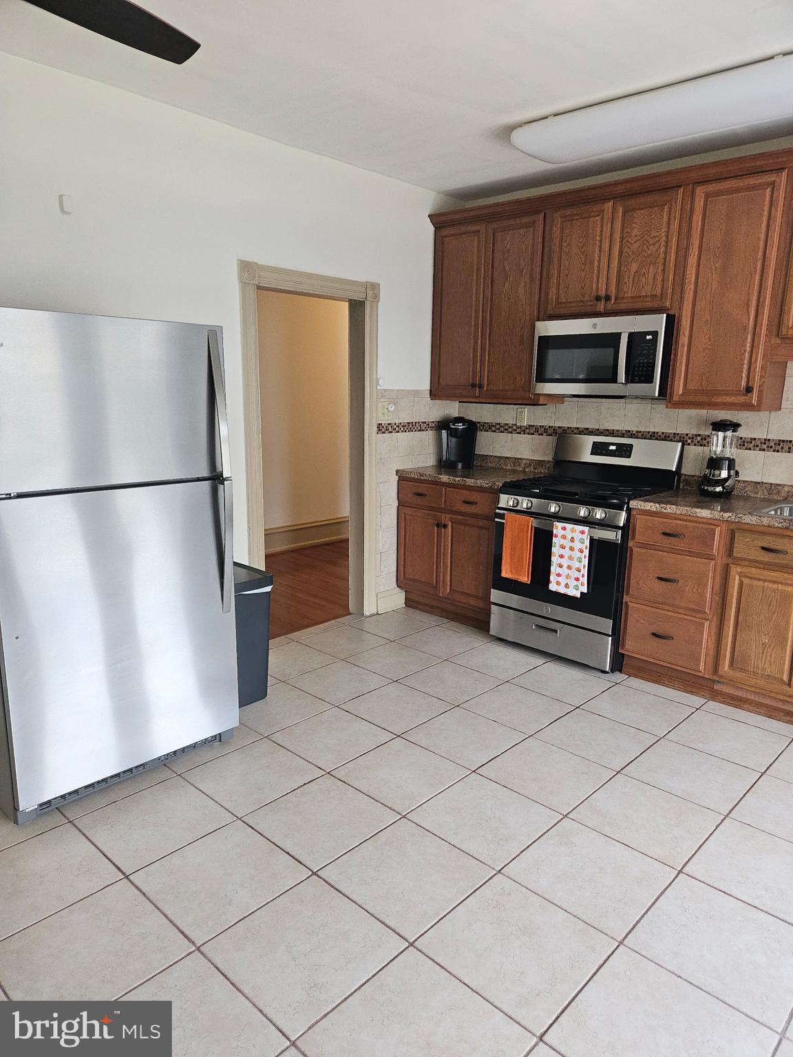 4356 Manayunk Avenue, Unit 2 Philadelphia, PA 19128 - Photo 37 of 43 a kitchen with stainless steel appliances granite countertop a refrigerator sink and microwave