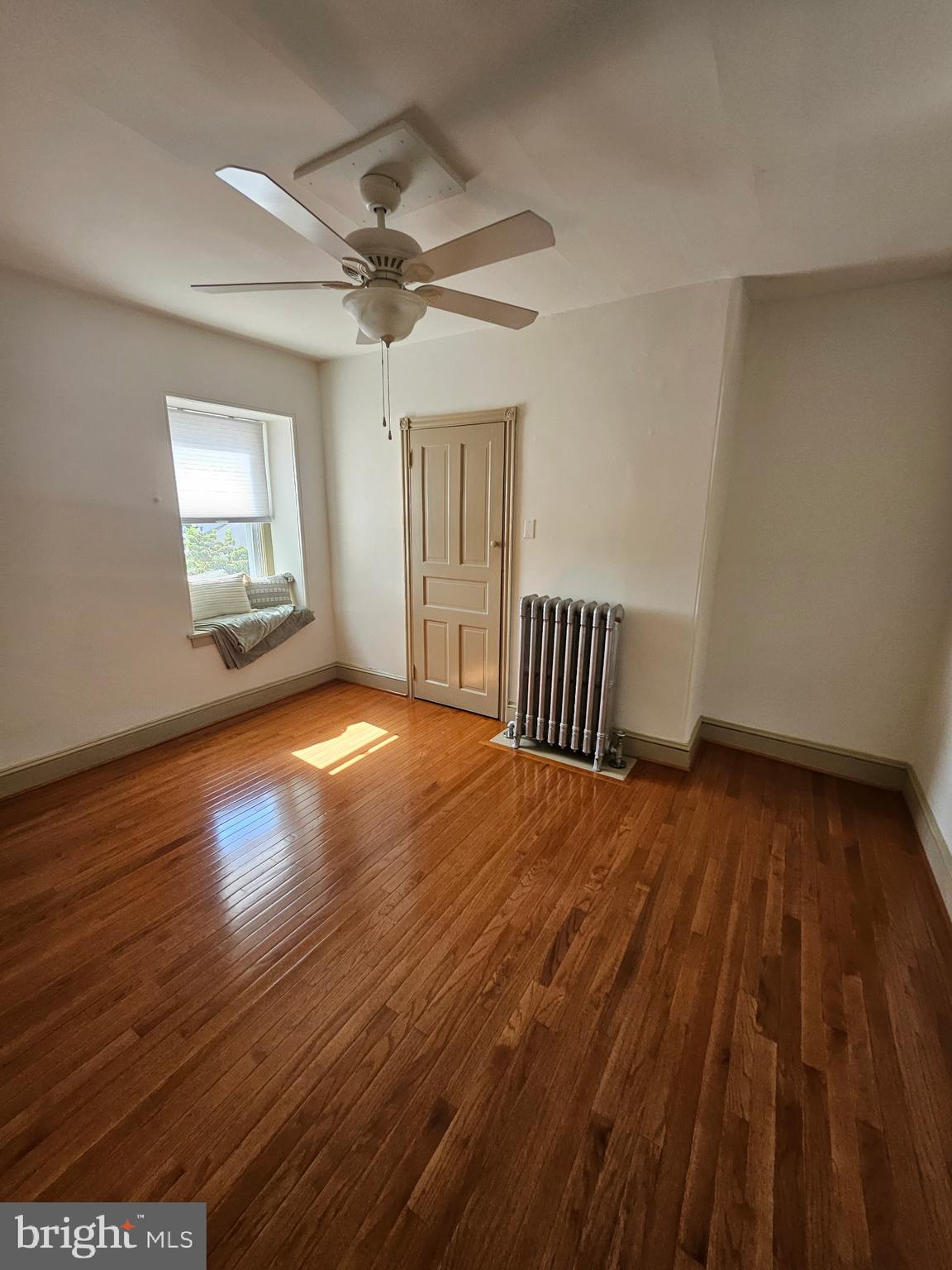 4356 Manayunk Avenue, Unit 2 Philadelphia, PA 19128 - Photo 38 of 43 a view of an empty room with wooden floor and a window