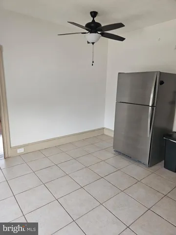 a view of a refrigerator and cabinets