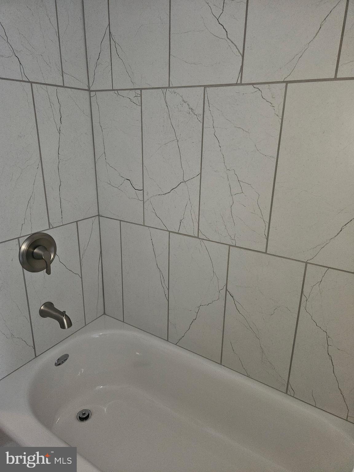 4356 Manayunk Avenue, Unit 2 Philadelphia, PA 19128 - Photo 8 of 43 a bathroom with a white bath tub and a sink