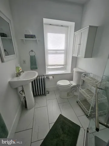 a bathroom with a sink toilet a mirror and tub
