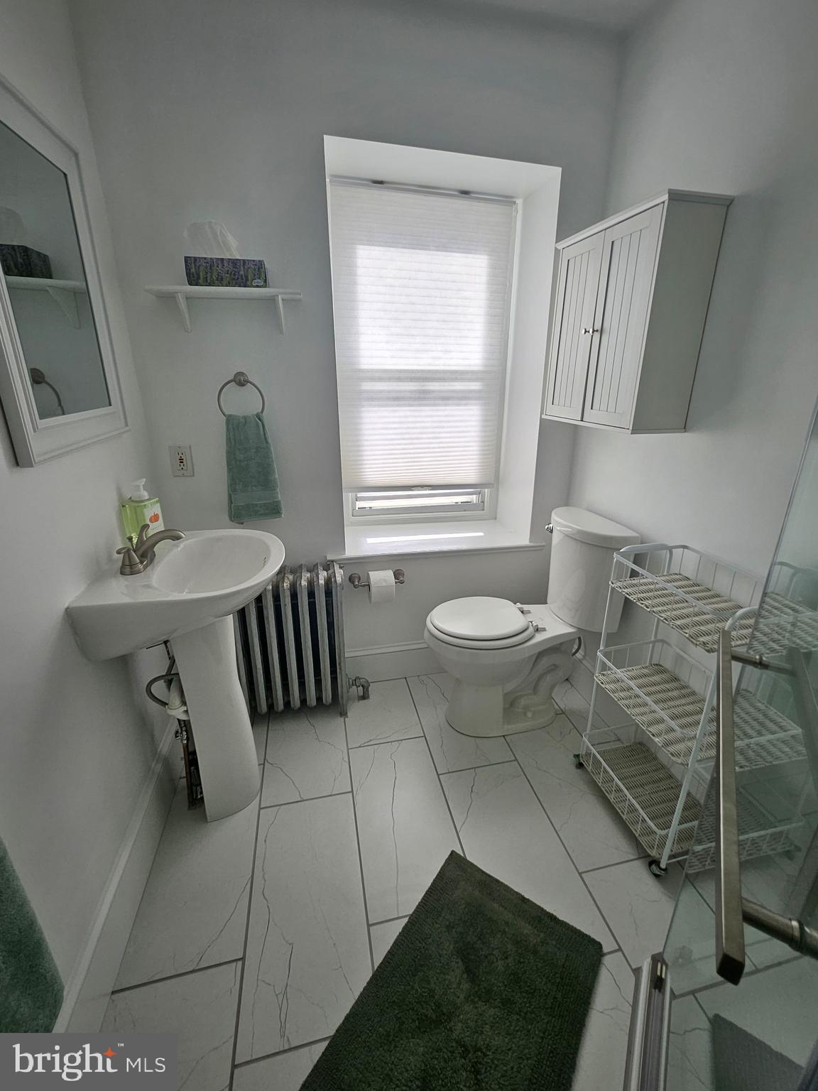 4356 Manayunk Avenue, Unit 2 Philadelphia, PA 19128 - Photo 10 of 43 a bathroom with a sink toilet a mirror and tub