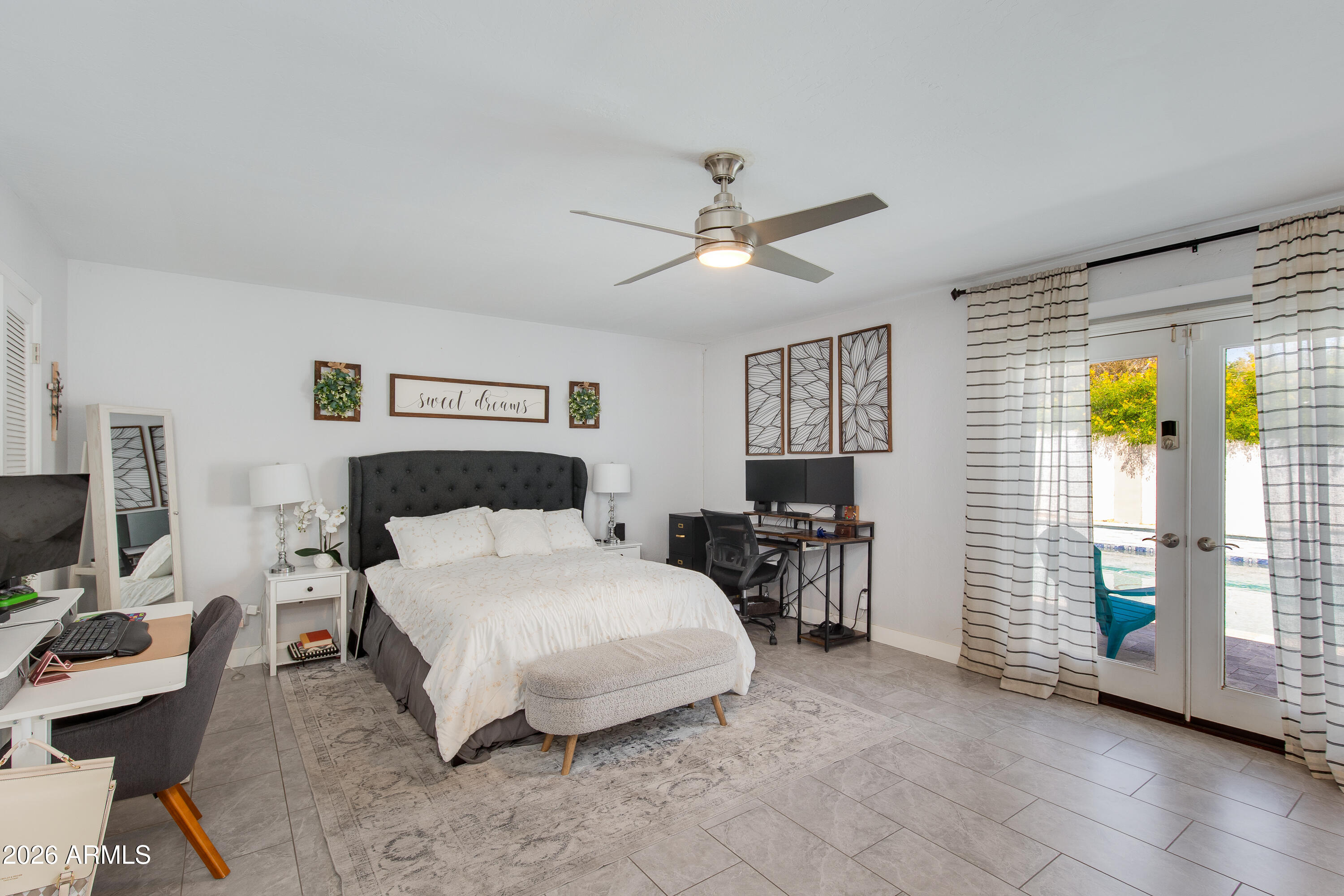 8219 North 3rd Avenue Phoenix, AZ 85021 - Photo 28 of 52 a bedroom with a large bed a chandelier and a flat tv screen