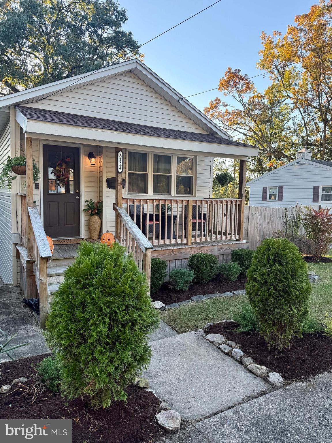 a view of a house with a yard and sitting area