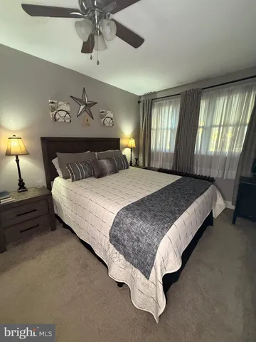 a spacious bedroom with a bed and window