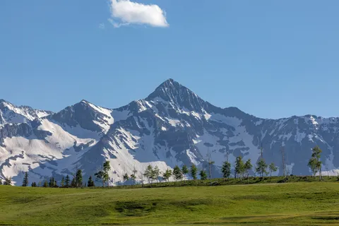 a view of an ocean with a mountain in the background