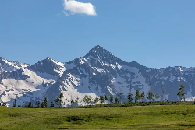 a view of an ocean with a mountain in the background