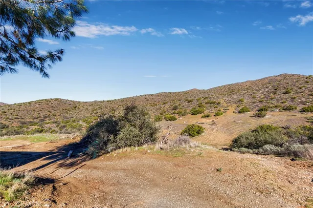 a view of mountain with wooden fence