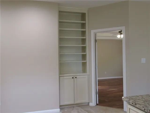 a view of walk in closet with empty racks