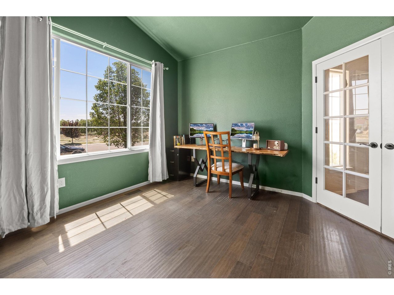 8847 16th St Road Greeley, CO 80634 - Photo 32 of 38 a view of a room with wooden floor and furniture