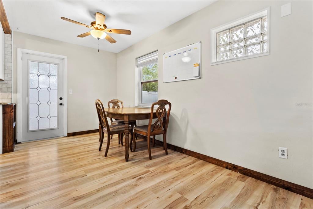 6221 Dalton Street Spring Hill, FL 34606 - Photo 25 of 40 a view of a dining room with furniture and wooden floor