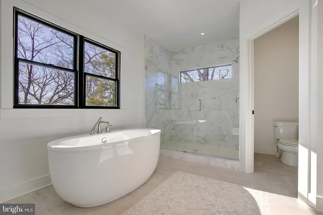 a bathroom with a bathtub and toilet