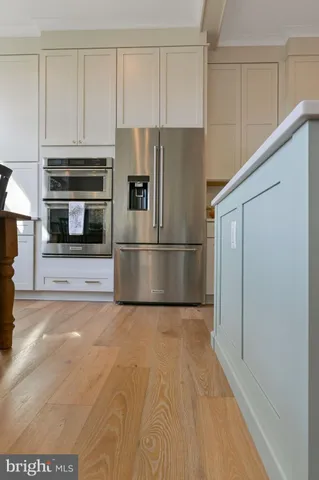 a kitchen with cabinets and stainless steel appliances