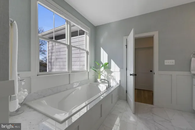 a spacious bathroom with a tub and shower
