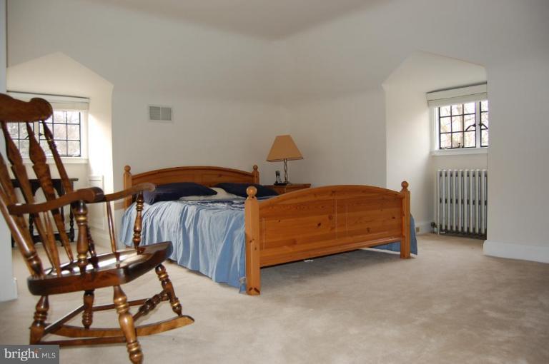 101 Overhill Road Baltimore, MD 21210 - Photo 12 of 24 a bedroom with a bed and a chair