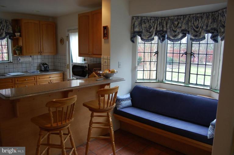 101 Overhill Road Baltimore, MD 21210 - Photo 14 of 24 a kitchen with a table chairs and a window