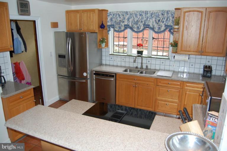 101 Overhill Road Baltimore, MD 21210 - Photo 23 of 24 a kitchen with granite countertop a refrigerator and a sink