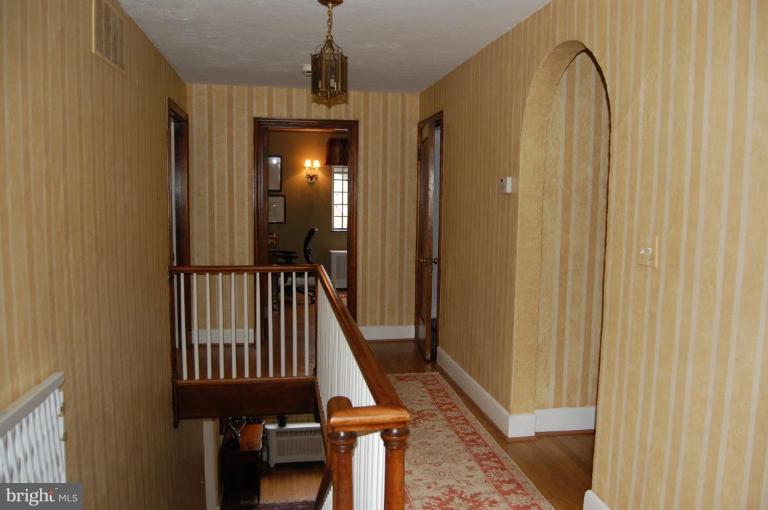 101 Overhill Road Baltimore, MD 21210 - Photo 10 of 24 a view of a balcony with wooden floor and staircase