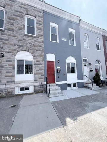 a front view of a house with a sitting area