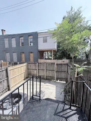 a view of a house with backyard and deck