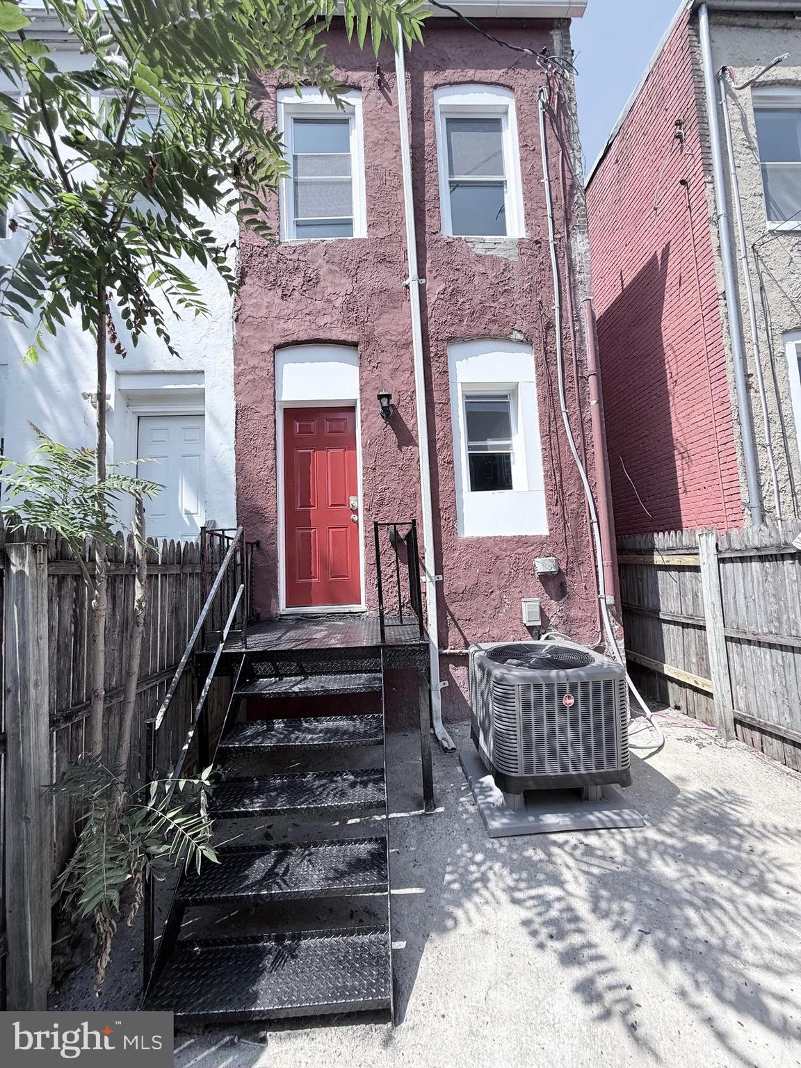 2415 Federal Street Baltimore, MD 21213 - Photo 17 of 35 a view of a house with a large window and wooden fence