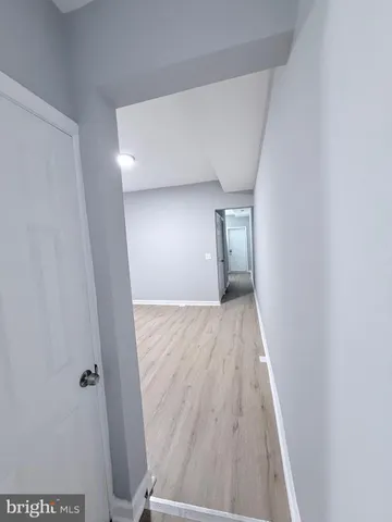 a view of hallway with wooden floor