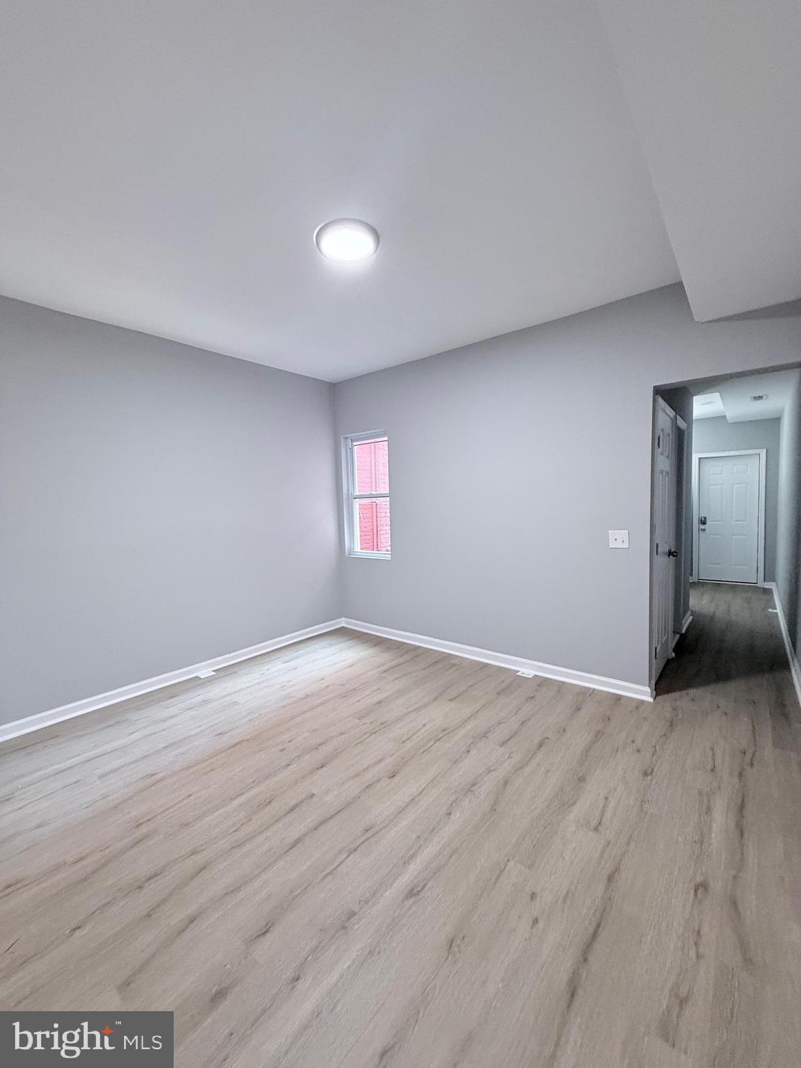 2415 Federal Street Baltimore, MD 21213 - Photo 8 of 35 an empty room with wooden floor and windows