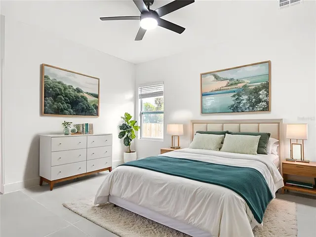 a bedroom with a bed and a chandelier